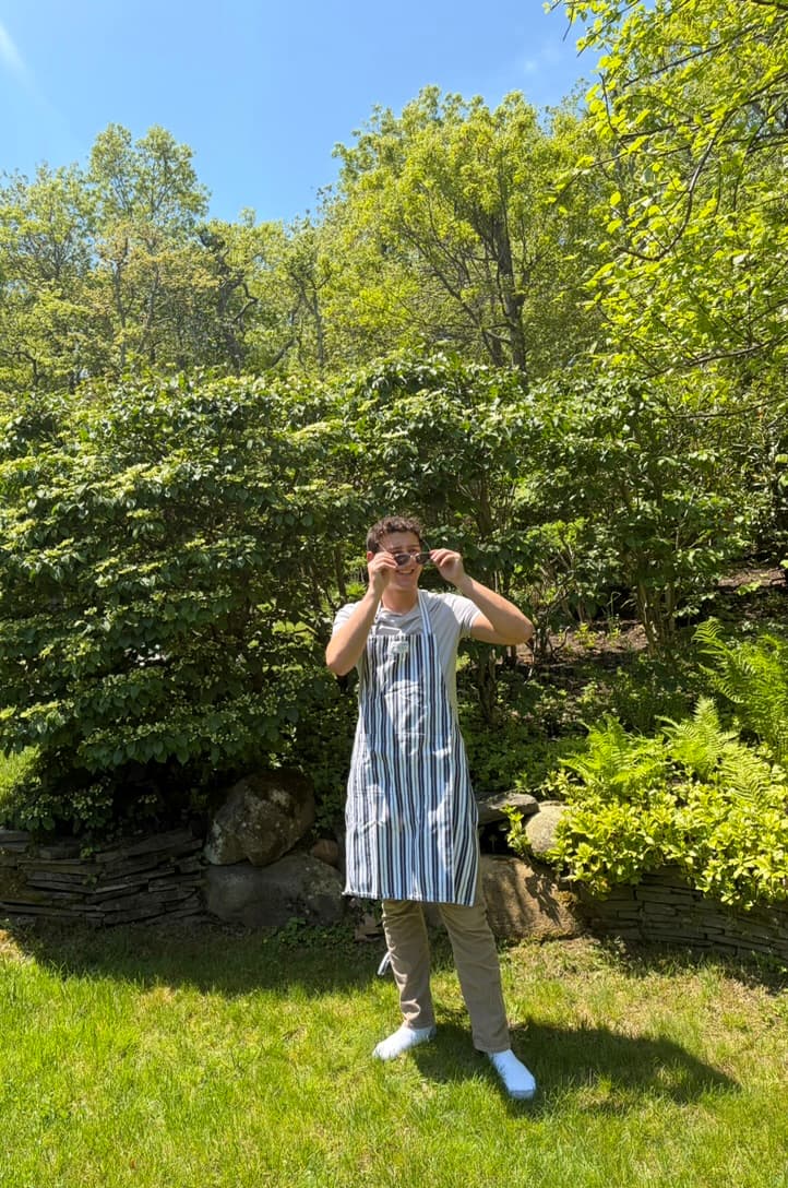 Dash Weintraub in an apron putting on glasses