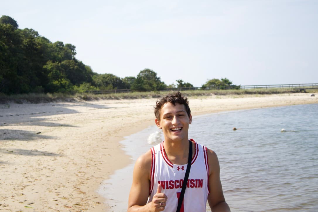 Dash Weintraub smiling on the beach in the Hamptons
